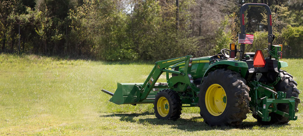 Green tractor with attachment