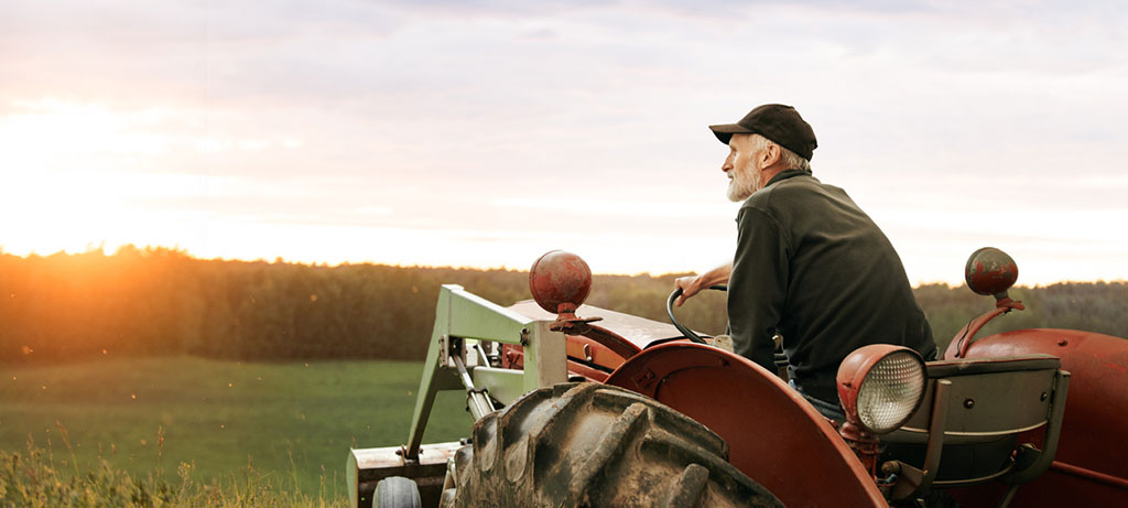 Man sitting on tractor watching field