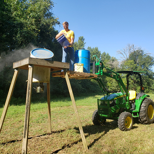 Guy standing on a pallet fork